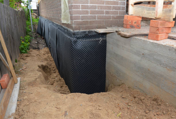 Happy homeowners after waterproofing job in Grand Marsh